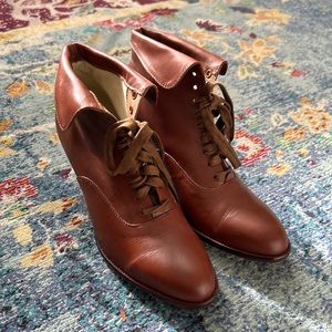 Brown lace up heeled boots.